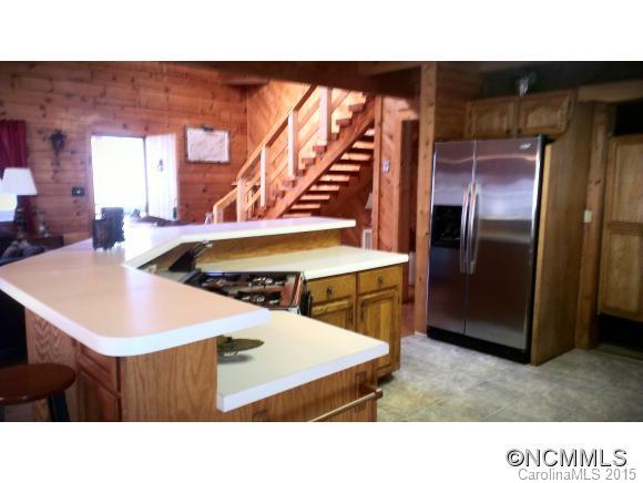 2406 Hemphill Road Waynesville, NC 28785 - Photo 9 of 19 a kitchen with a sink a counter top space and stainless steel appliances