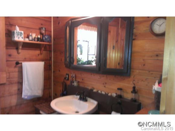 2406 Hemphill Road Waynesville, NC 28785 - Photo 10 of 19 a bathroom with a sink and a mirror