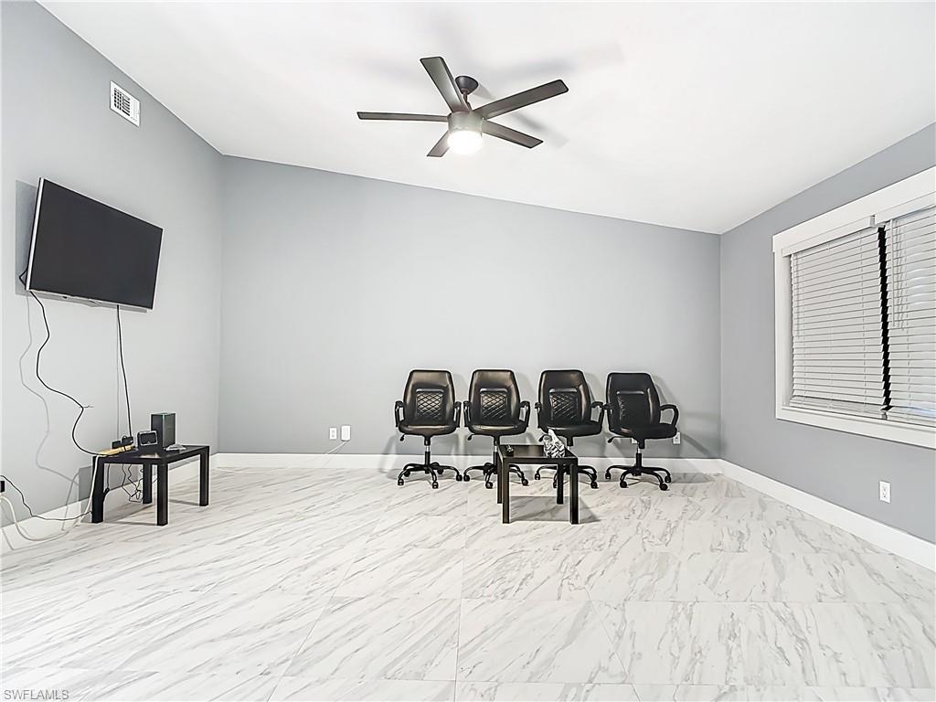 183 Round Key Circle, Unit D4 Naples, FL 34112 - Photo 13 of 49 a work room with table chairs and wooden floor