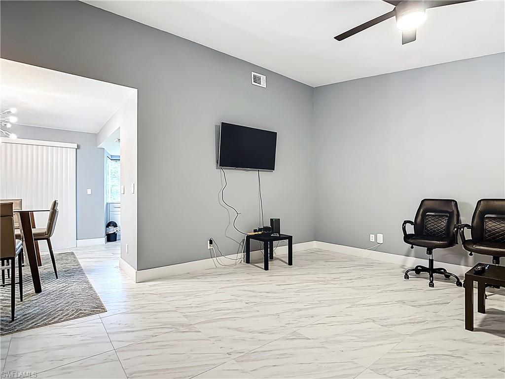183 Round Key Circle, Unit D4 Naples, FL 34112 - Photo 14 of 49 a view of a workspace with furniture and wooden floor