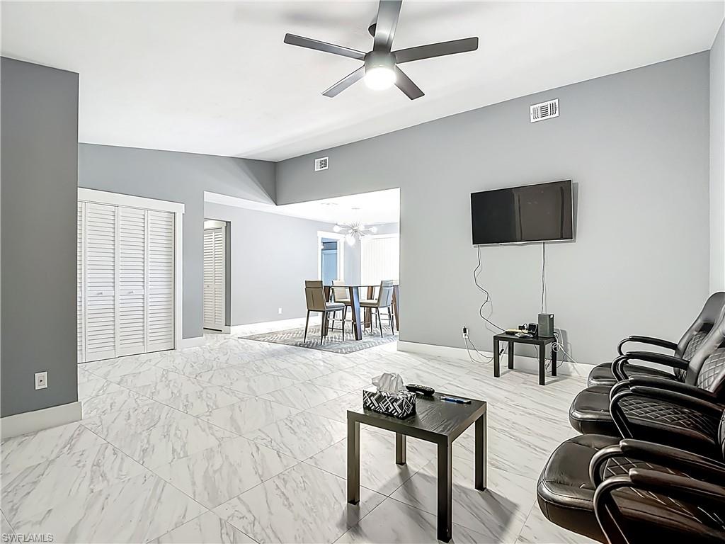 183 Round Key Circle, Unit D4 Naples, FL 34112 - Photo 15 of 49 a living room with furniture and a flat screen tv