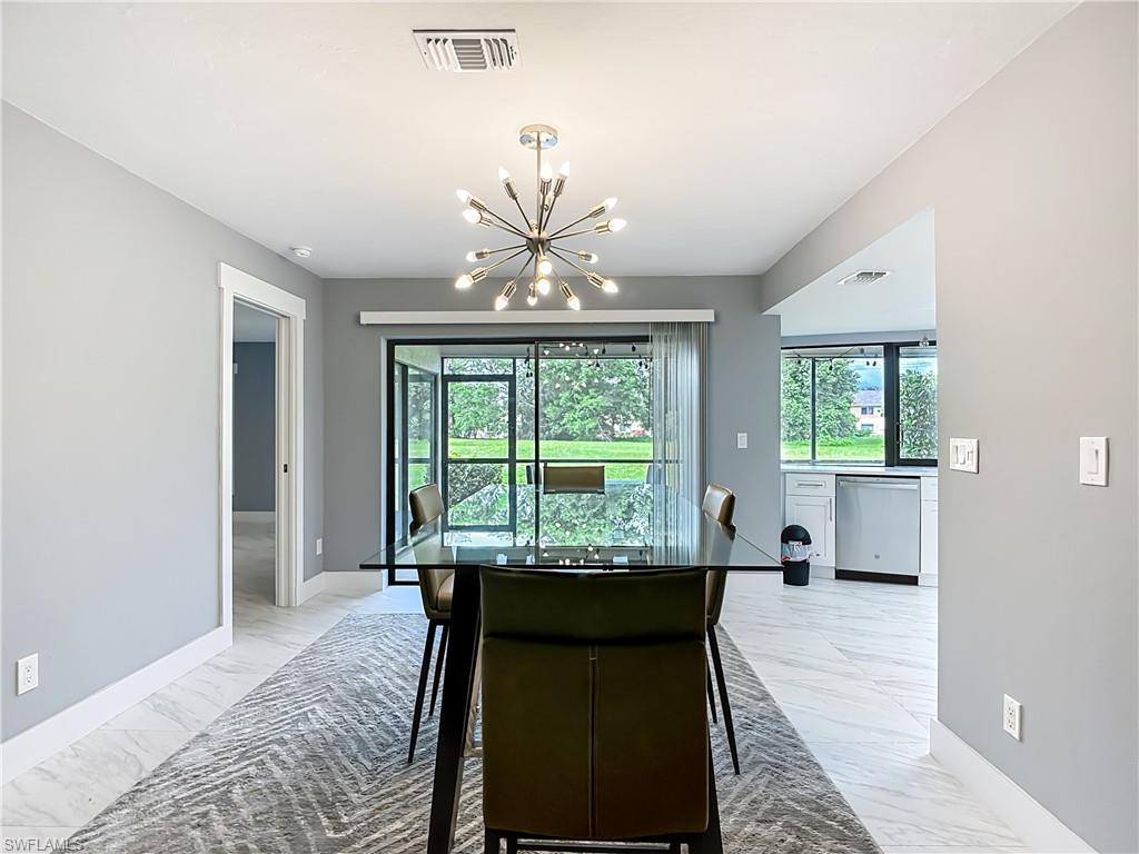 183 Round Key Circle, Unit D4 Naples, FL 34112 - Photo 20 of 49 a living room with furniture and a large window