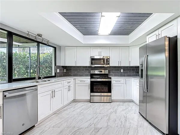 a kitchen with a stove a sink and a microwave
