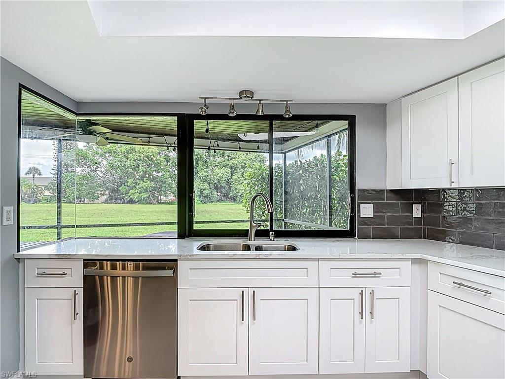 183 Round Key Circle, Unit D4 Naples, FL 34112 - Photo 25 of 49 a kitchen with a sink and large window
