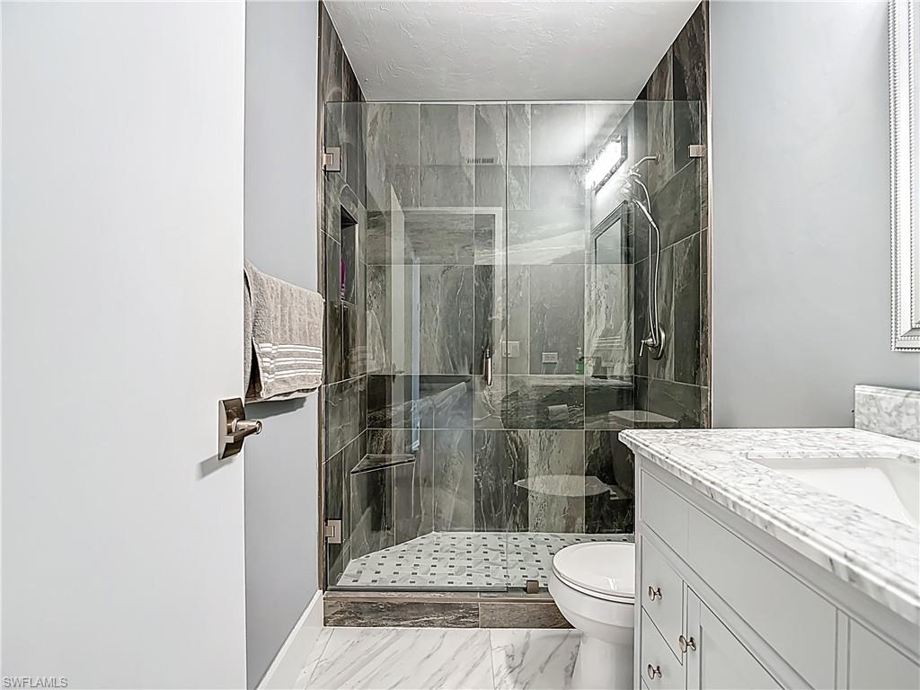 183 Round Key Circle, Unit D4 Naples, FL 34112 - Photo 29 of 49 a bathroom with a sink a toilet and shower
