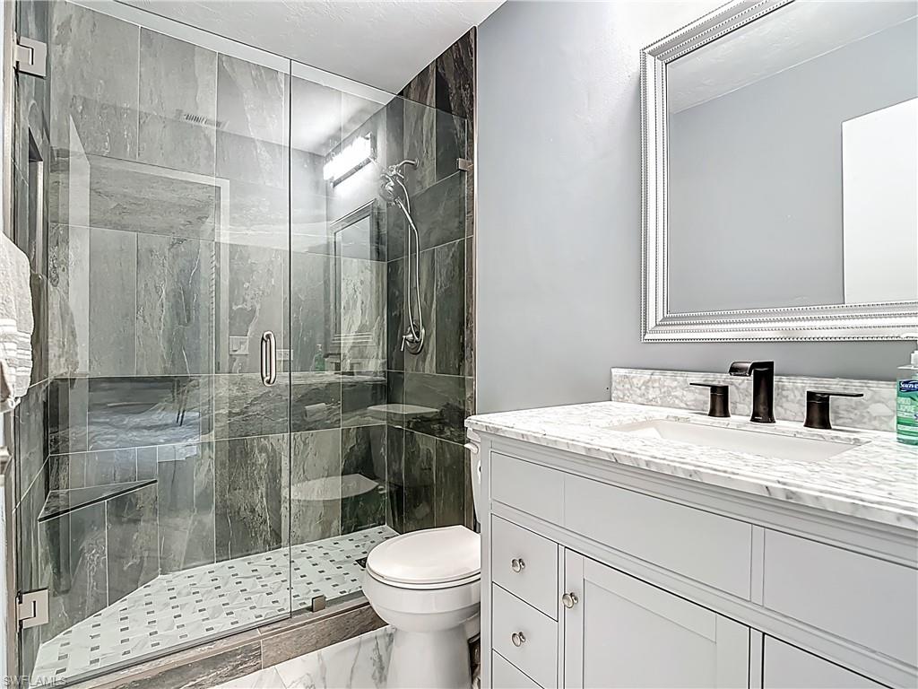 183 Round Key Circle, Unit D4 Naples, FL 34112 - Photo 30 of 49 a bathroom with a sink toilet and shower