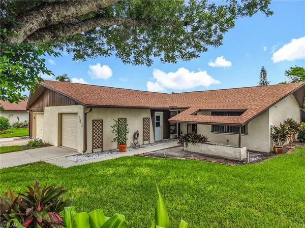 a front view of house with yard and outdoor seating