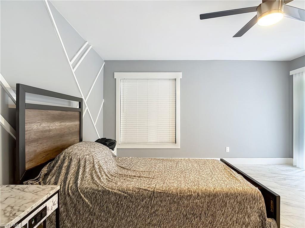 183 Round Key Circle, Unit D4 Naples, FL 34112 - Photo 32 of 49 a bedroom with a bed and a window