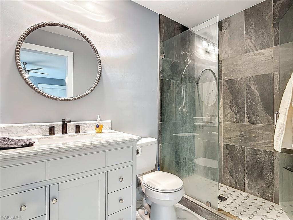 183 Round Key Circle, Unit D4 Naples, FL 34112 - Photo 37 of 49 a bathroom with a sink and a mirror