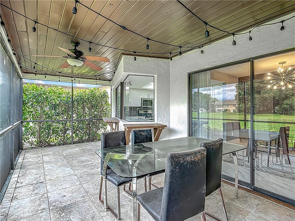 183 Round Key Circle, Unit D4 Naples, FL 34112 - Photo 44 of 49 a living room with furniture and a floor to ceiling window