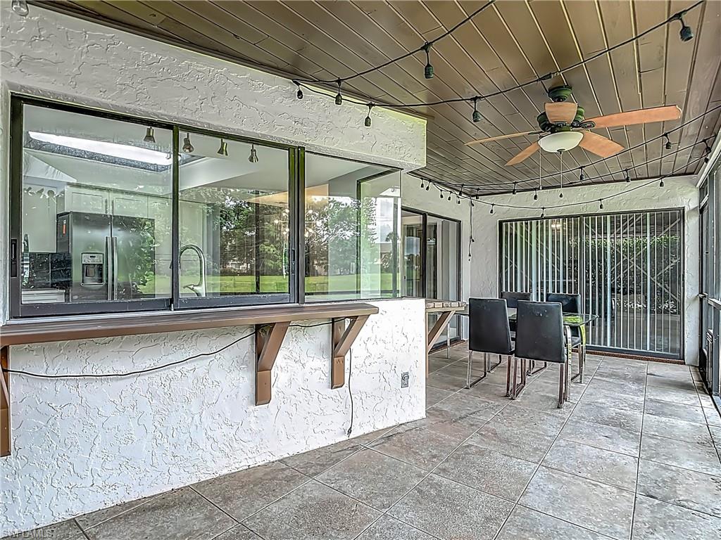 183 Round Key Circle, Unit D4 Naples, FL 34112 - Photo 47 of 49 a living room with furniture and large windows