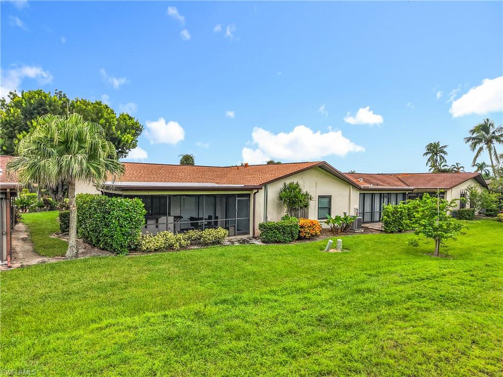 183 Round Key Circle, Unit D4 Naples, FL 34112 - Photo 48 of 49 a front view of a house with garden