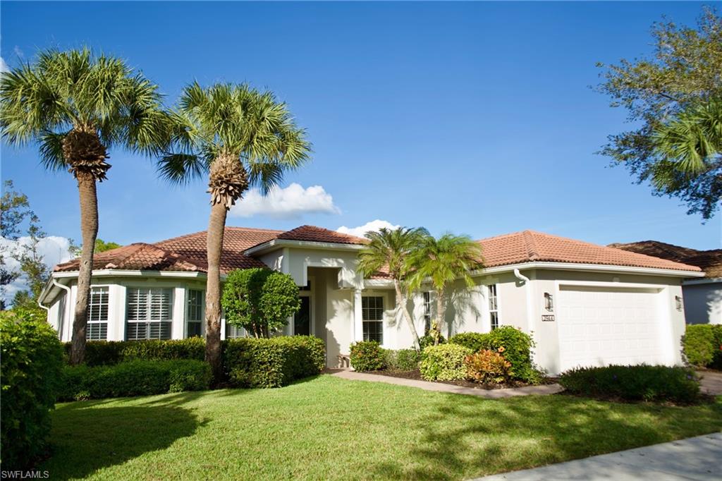 a front view of a house with a yard and potted plants