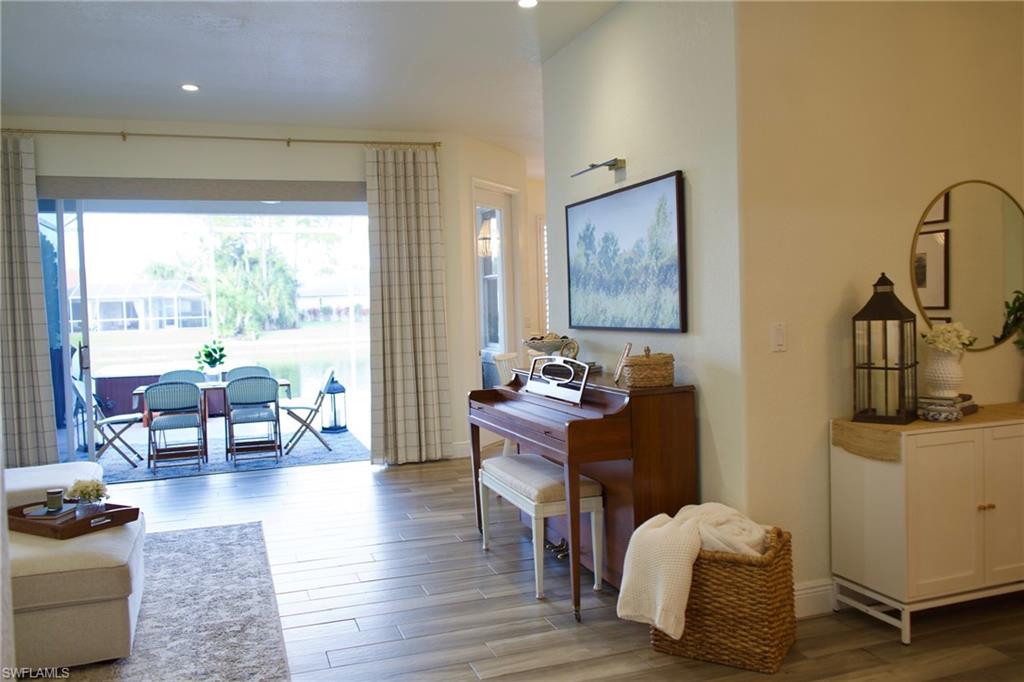 3944 Ruxton Road Naples, FL 34116 - Photo 11 of 27 a living room with furniture and a table