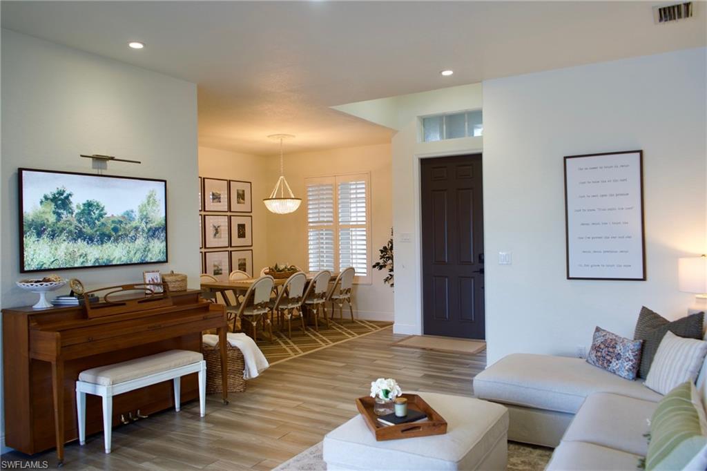 3944 Ruxton Road Naples, FL 34116 - Photo 12 of 27 a living room with furniture and wooden floor