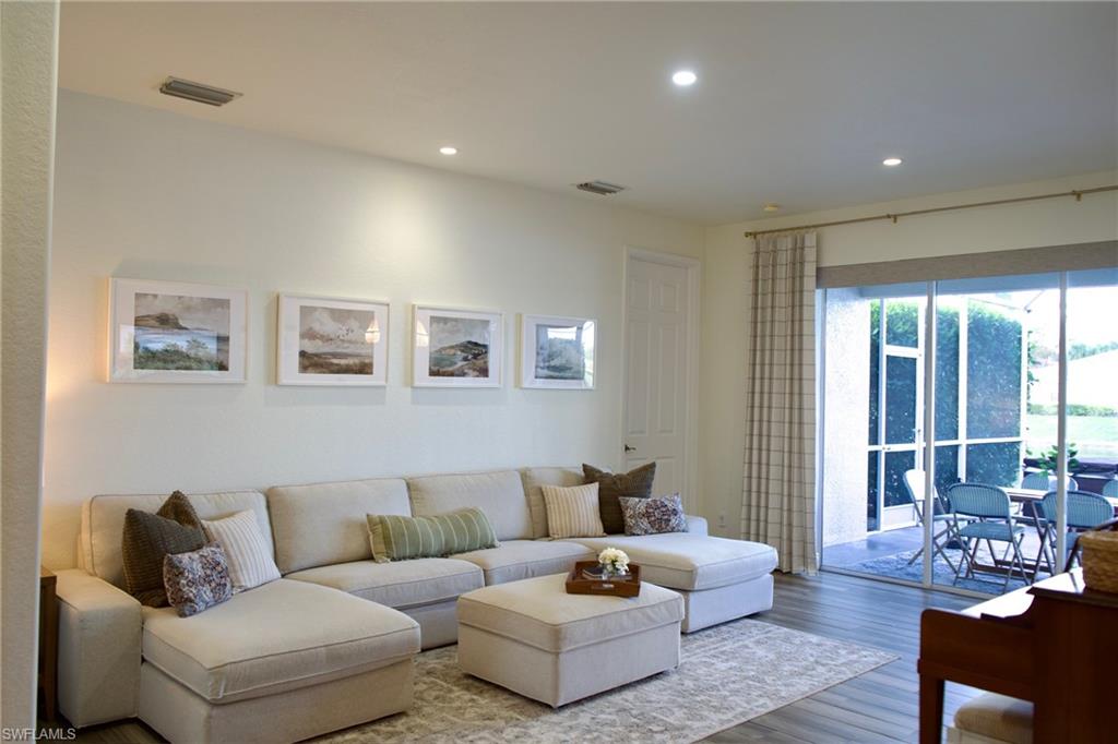 3944 Ruxton Road Naples, FL 34116 - Photo 13 of 27 a living room with furniture and a large window