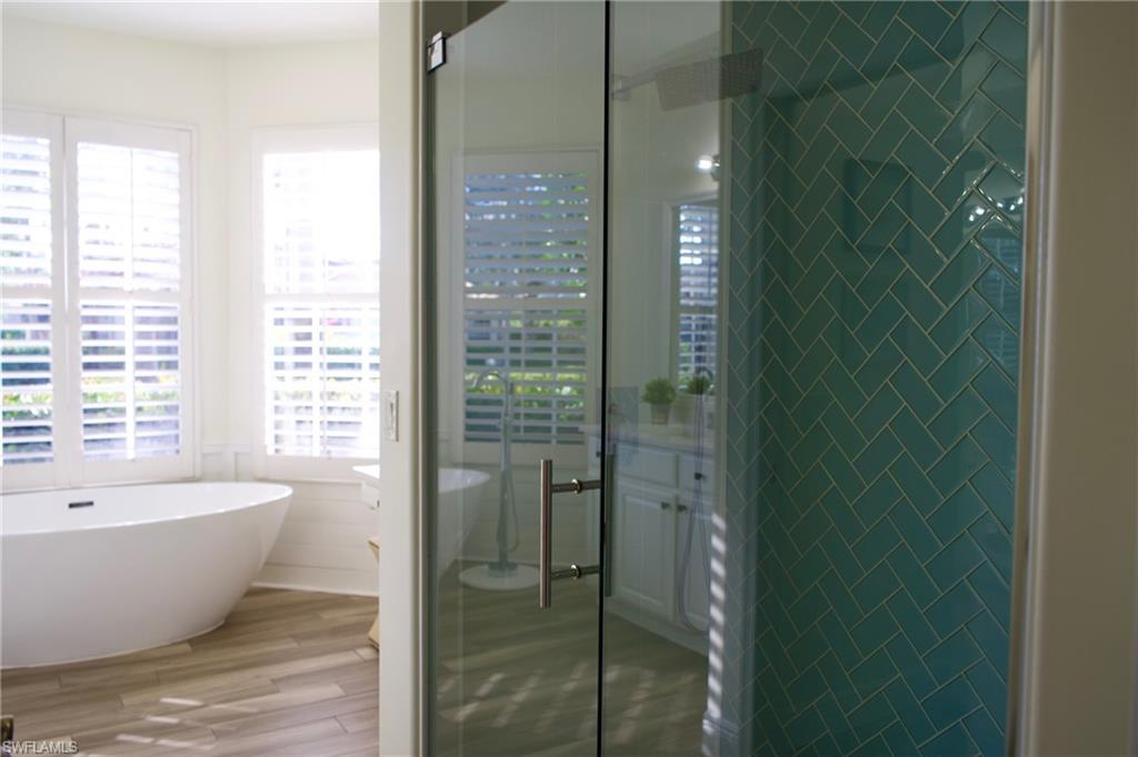 3944 Ruxton Road Naples, FL 34116 - Photo 19 of 27 a bathroom with a bathtub and shower