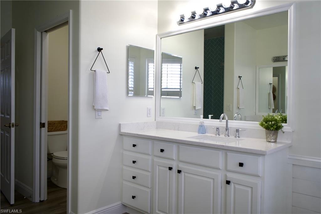 3944 Ruxton Road Naples, FL 34116 - Photo 20 of 27 a bathroom with a double vanity sink mirror and double