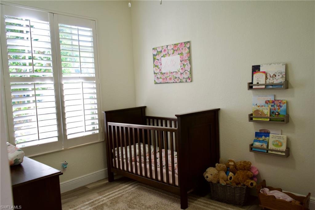 3944 Ruxton Road Naples, FL 34116 - Photo 26 of 27 a bedroom with furniture and a window