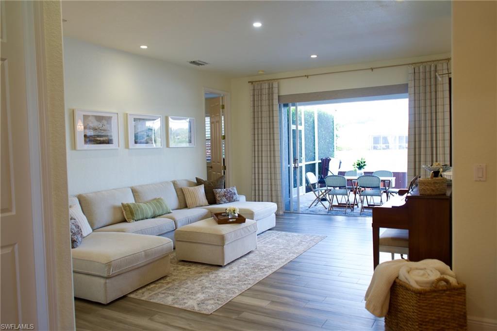 3944 Ruxton Road Naples, FL 34116 - Photo 10 of 27 a living room with furniture and a large window