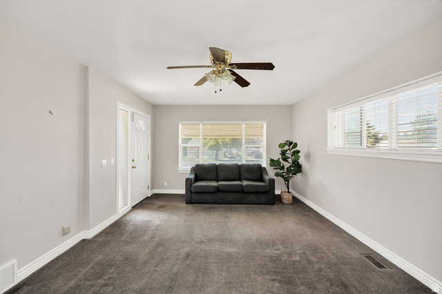 80 North 500 West Logan, UT 84321 - Photo 4 of 36 Recessed lighting, ceiling fan, carpet flooring, multiple windows, and a white entry door