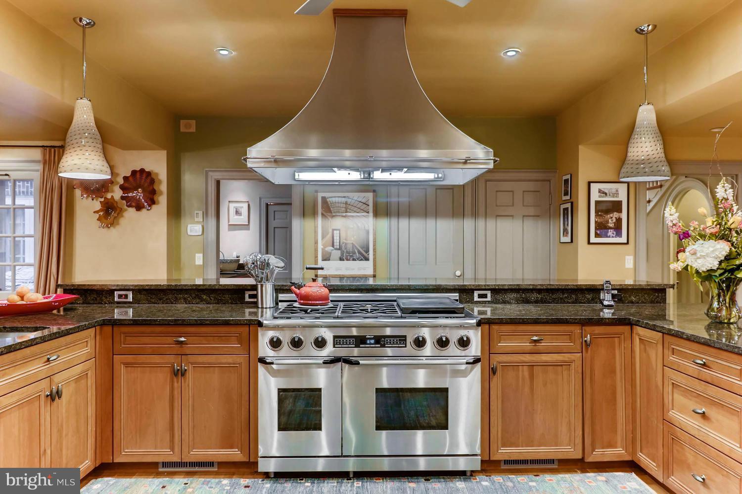 301 Somerset Road Baltimore, MD 21210 - Photo 14 of 30 a kitchen with stainless steel appliances granite countertop a stove a sink and a microwave