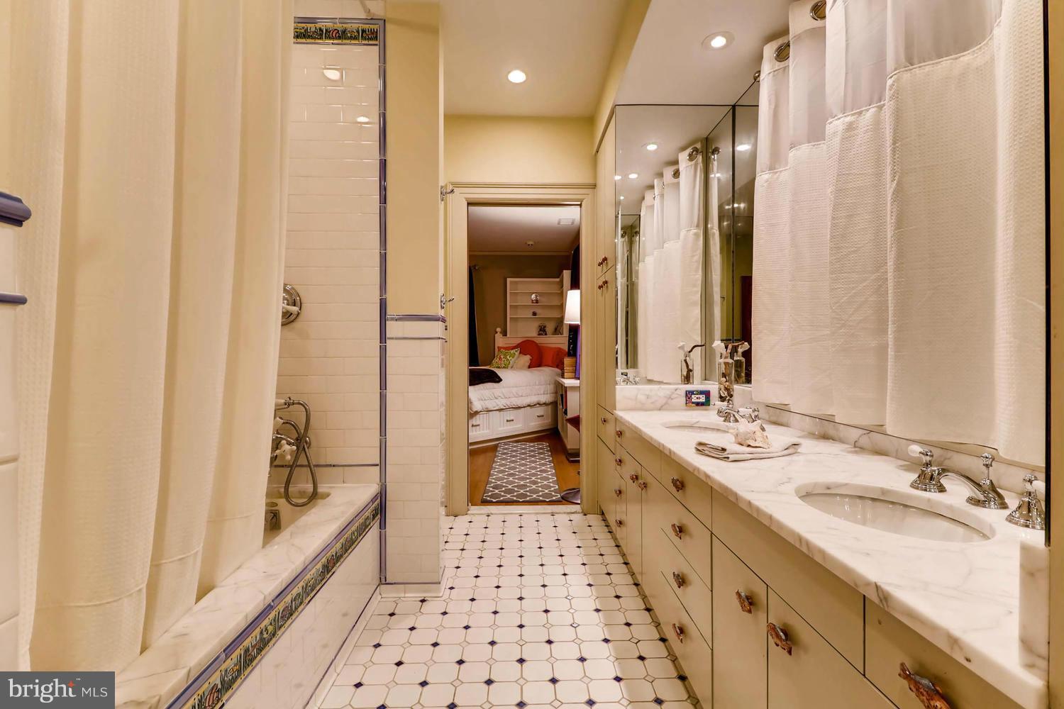 301 Somerset Road Baltimore, MD 21210 - Photo 22 of 30 a bathroom with double vanity and a bathtub