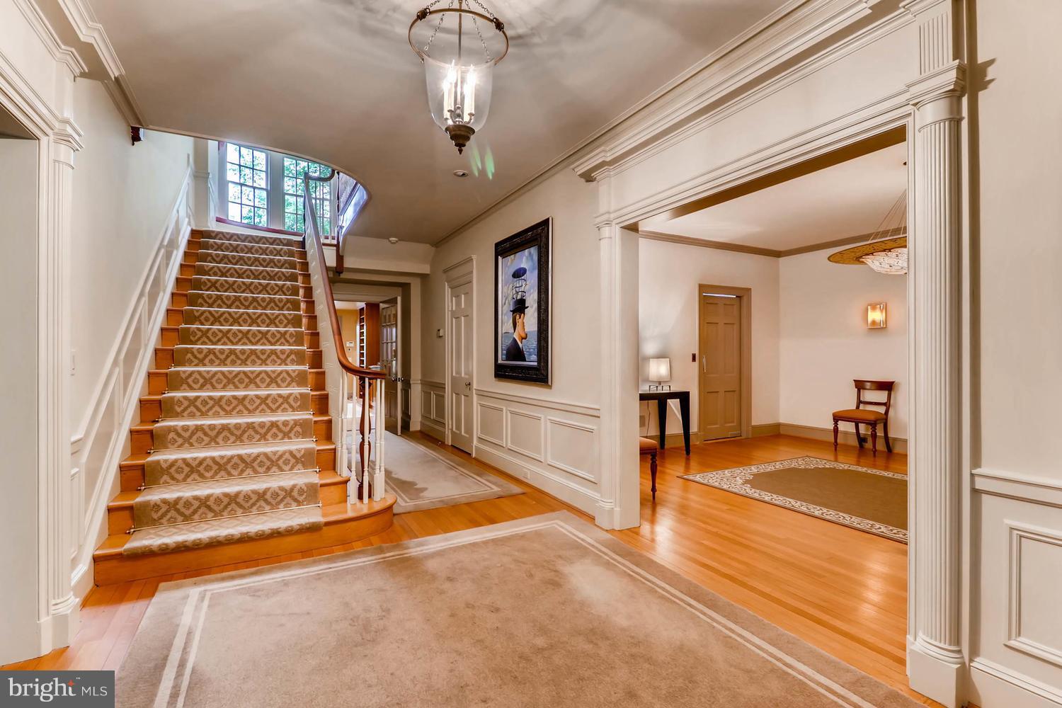 301 Somerset Road Baltimore, MD 21210 - Photo 5 of 30 a view of a livingroom with wooden floor and stairs