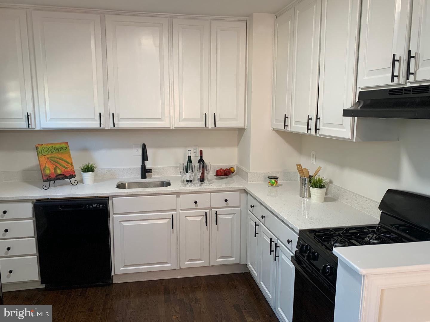 9407 Colesville Road Silver Spring, MD 20901 - Photo 13 of 47 Modern kitchen with sleek white cabinetry.