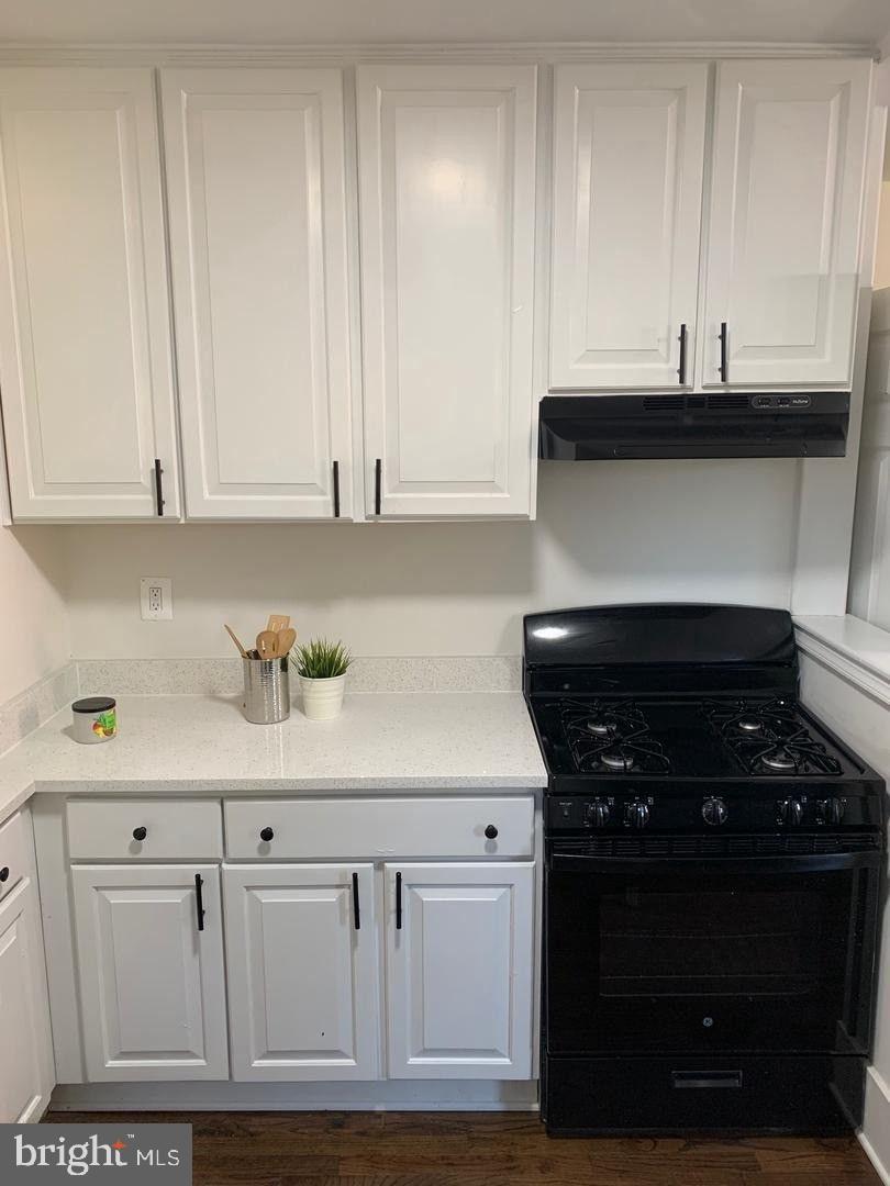 9407 Colesville Road Silver Spring, MD 20901 - Photo 15 of 47 Sleek kitchen with modern black appliances.