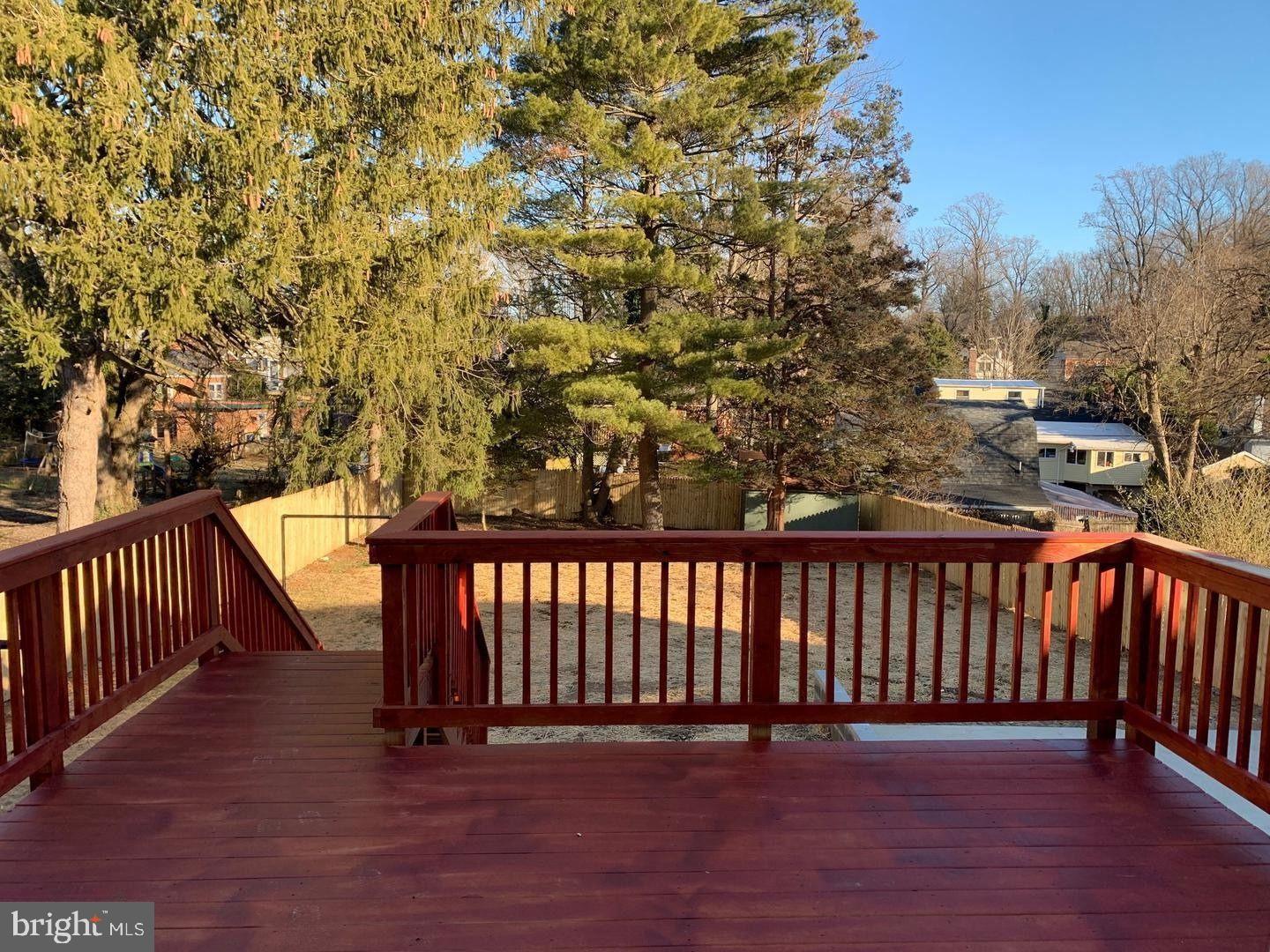 9407 Colesville Road Silver Spring, MD 20901 - Photo 40 of 43 Serene deck view amidst lush greenery.