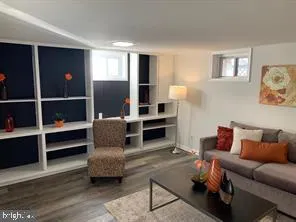 a living room with furniture and a lamp