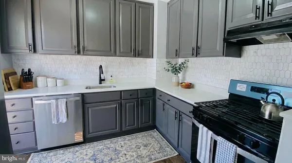 a kitchen with sink and cabinets