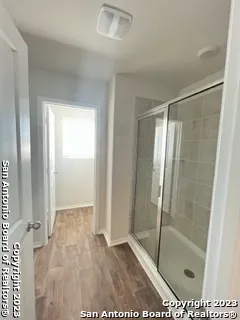 a bathroom with a glass shower door