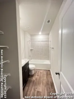 a bathroom with a tub a toilet and a shower