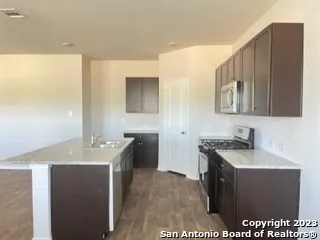 a kitchen with a sink and a stove top oven