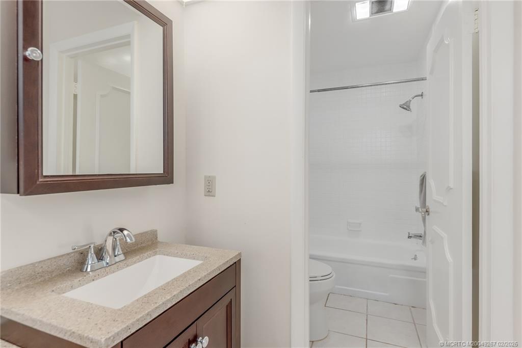 1743 Northwest Spruce Ridge Drive Stuart, FL 34994 - Photo 13 of 31 a bathroom with a sink vanity and mirror