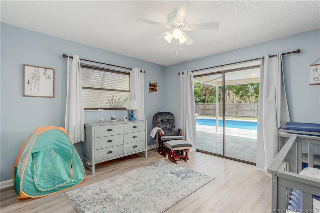 1743 Northwest Spruce Ridge Drive Stuart, FL 34994 - Photo 16 of 31 a living room with furniture and a dresser next to a window
