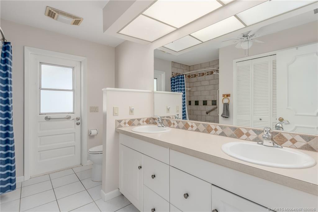 1743 Northwest Spruce Ridge Drive Stuart, FL 34994 - Photo 17 of 31 a bathroom with a sink and a mirror