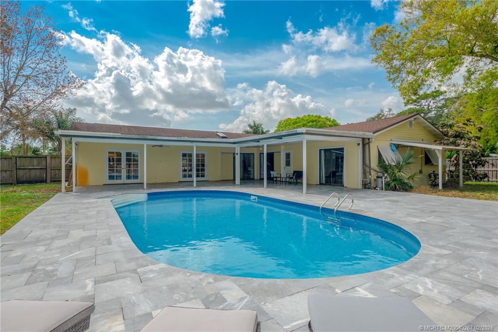 1743 Northwest Spruce Ridge Drive Stuart, FL 34994 - Photo 20 of 31 a view of house that has a yard