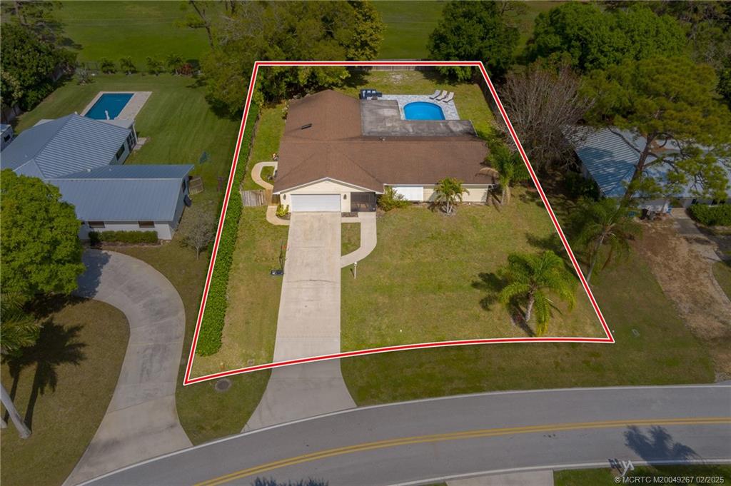 1743 Northwest Spruce Ridge Drive Stuart, FL 34994 - Photo 25 of 31 an aerial view of residential house with outdoor space