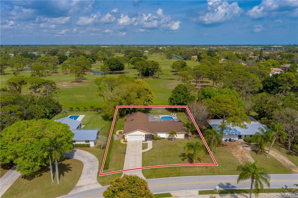 1743 Northwest Spruce Ridge Drive Stuart, FL 34994 - Photo 26 of 31 an aerial view of residential houses with outdoor space