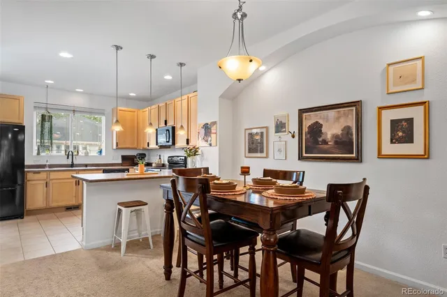 a dining room filled a chandelier a dining table and chairs