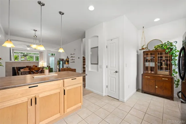 a kitchen with stainless steel appliances kitchen island granite countertop a refrigerator and a sink