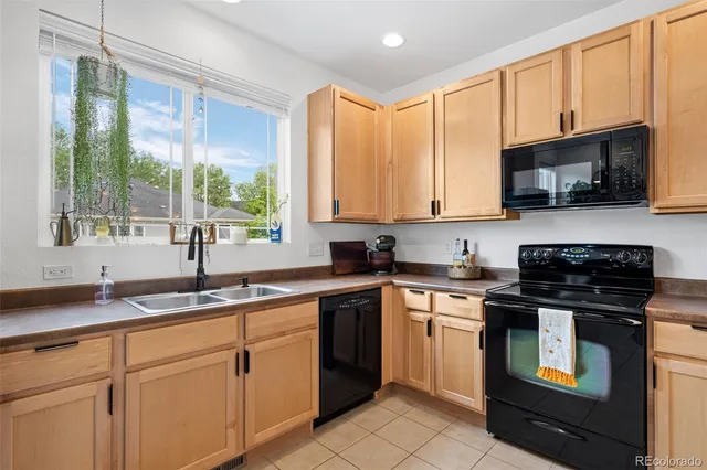 a kitchen with stainless steel appliances granite countertop white cabinets granite counter tops and a window