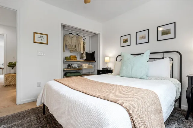 a bedroom with bed and mirror