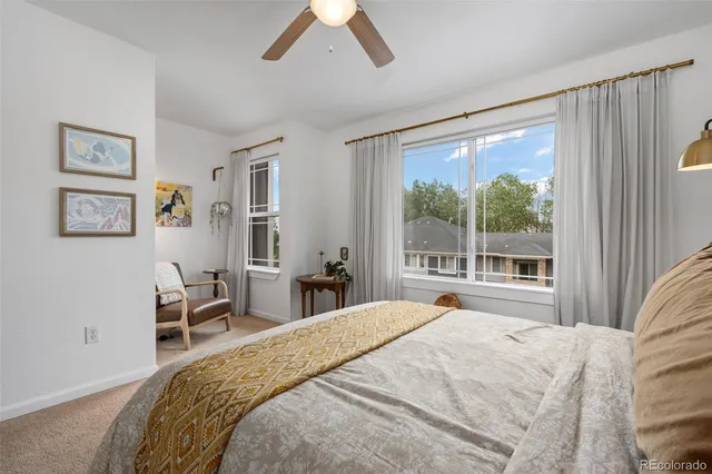 a bedroom with a large bed and a large window