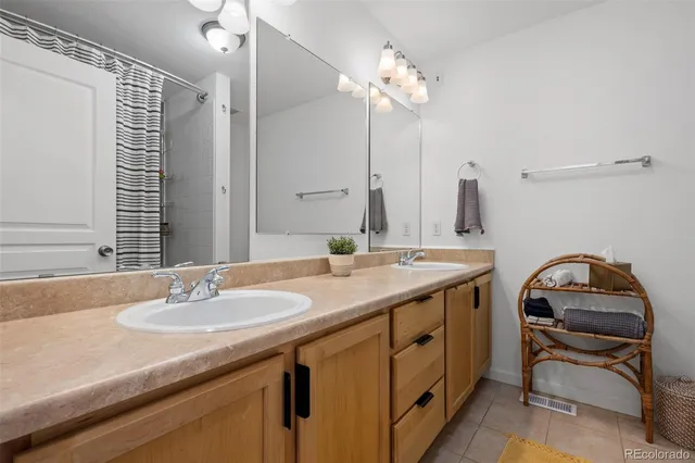 a bathroom with a sink double vanity and a mirror