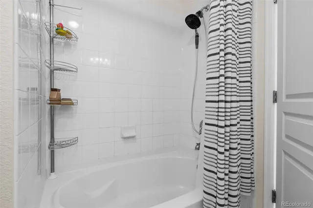 a bathroom with a bathtub and shower