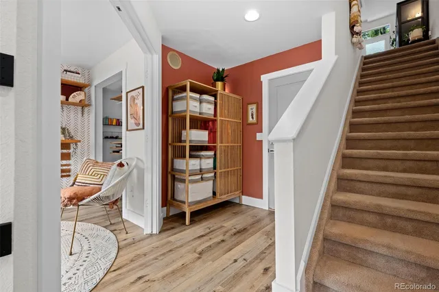 a view of front door with furniture and wooden floor